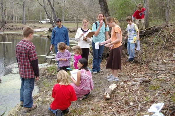 Students learning on the riverbank
